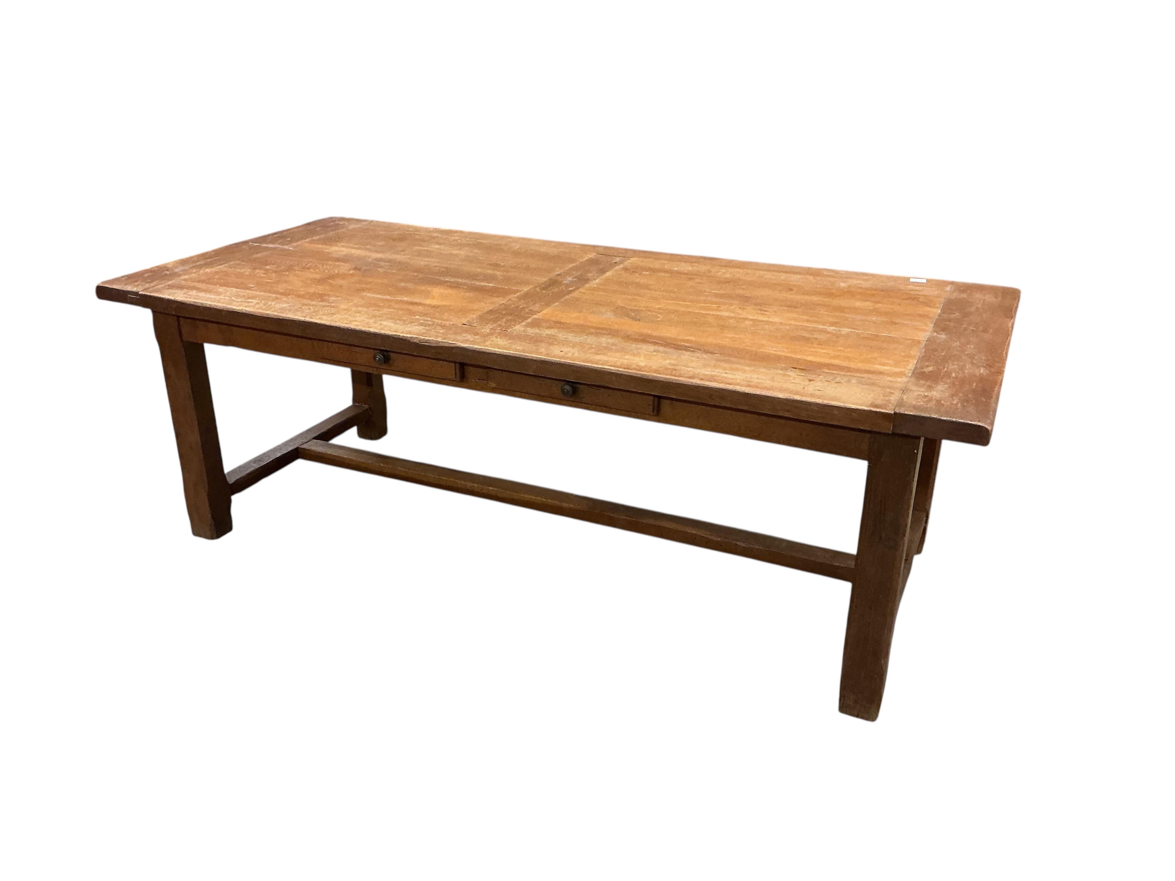 A Contemporary rectangular oak extending refectory dining table, width 320cm extended, two detachable end leaves, depth 100cm, height 76cm together with eight matching ladderback dining chairs, two with arms